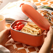 Lunch Box Chauffante Electrique Isotherme Inox Orange avec Sandwich entrain d'être ouverte